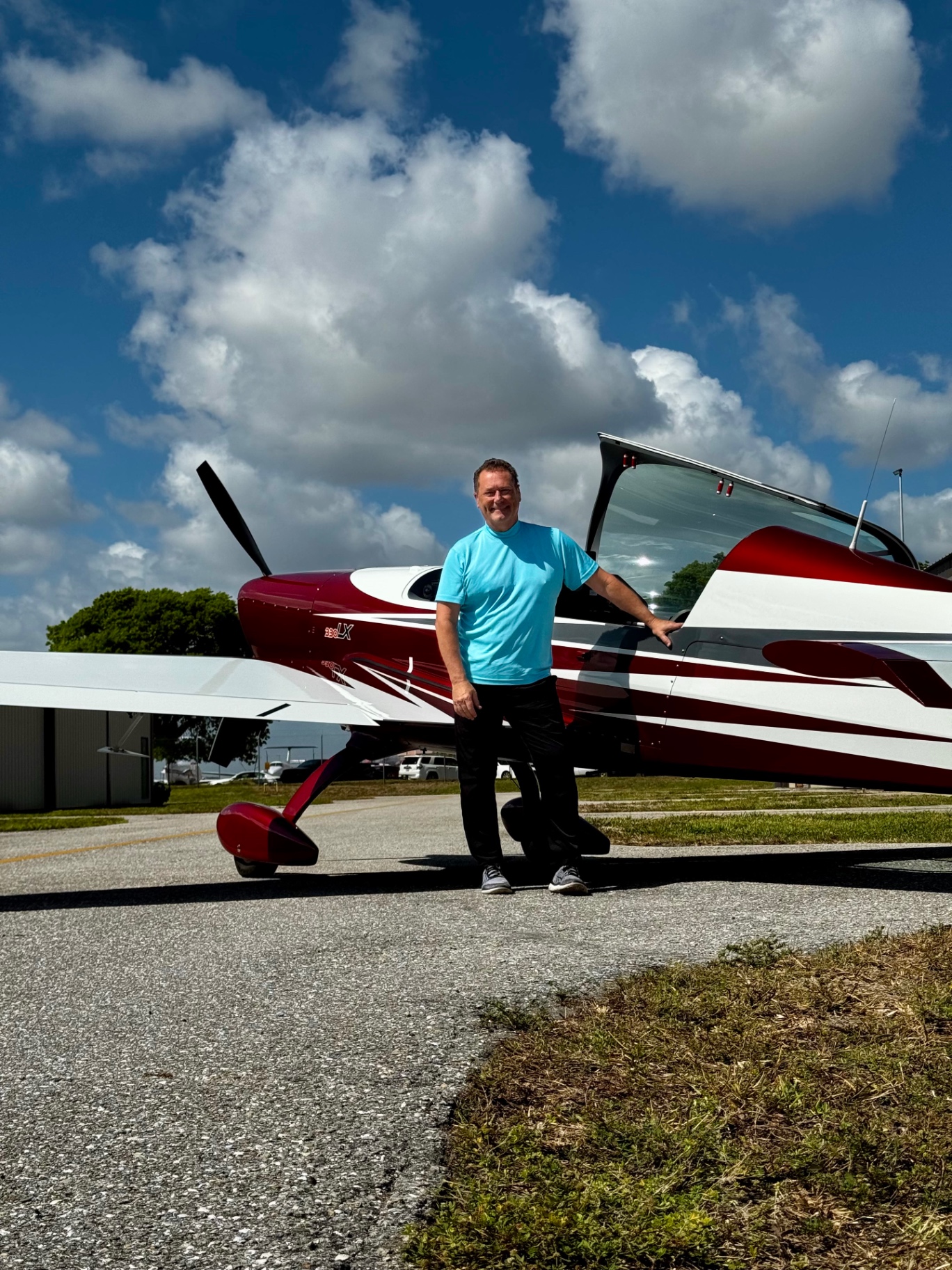 Christopher Magon beside the Extra 330